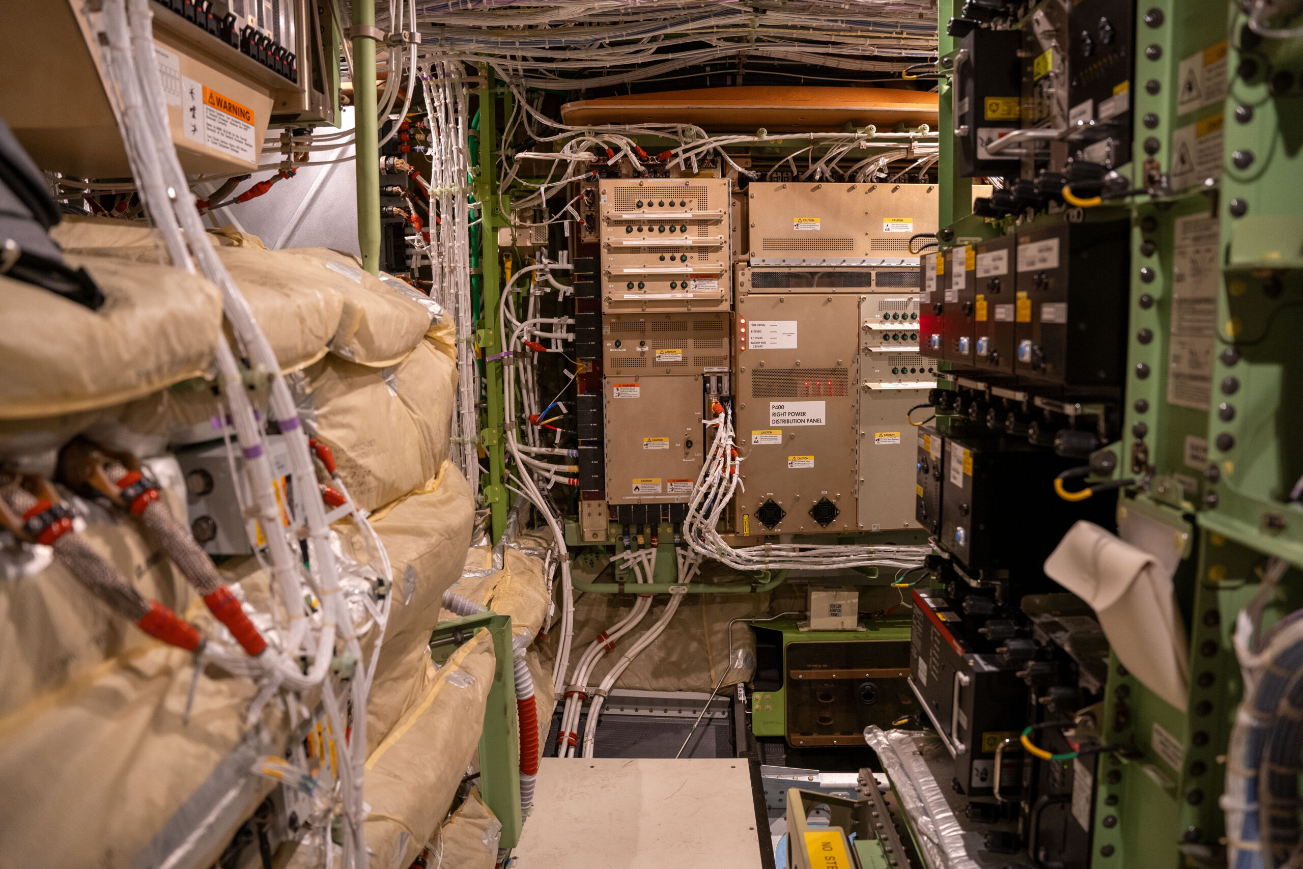 Electronic boxes and circuit breaker panels inside an electronics and equipment bay in a 787 commercial passenger airplane. photo of Mil-Spec Connectors