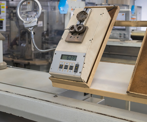 Silhouetted front view of a large military cargo aircraft on a runway during sunset, with its wings and engines casting shadows.